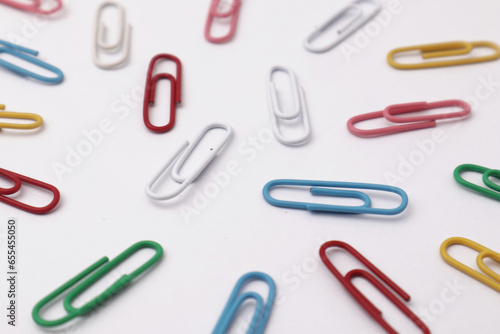 Colorful paper clip office business supplies isolated on white