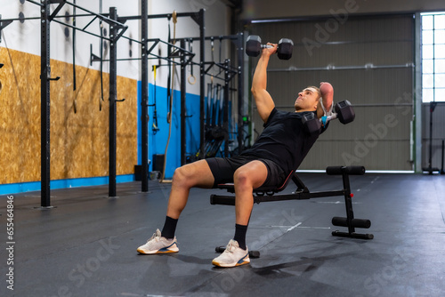 Wallpaper Mural Disabled man exercising with dumbbells in a gym Torontodigital.ca