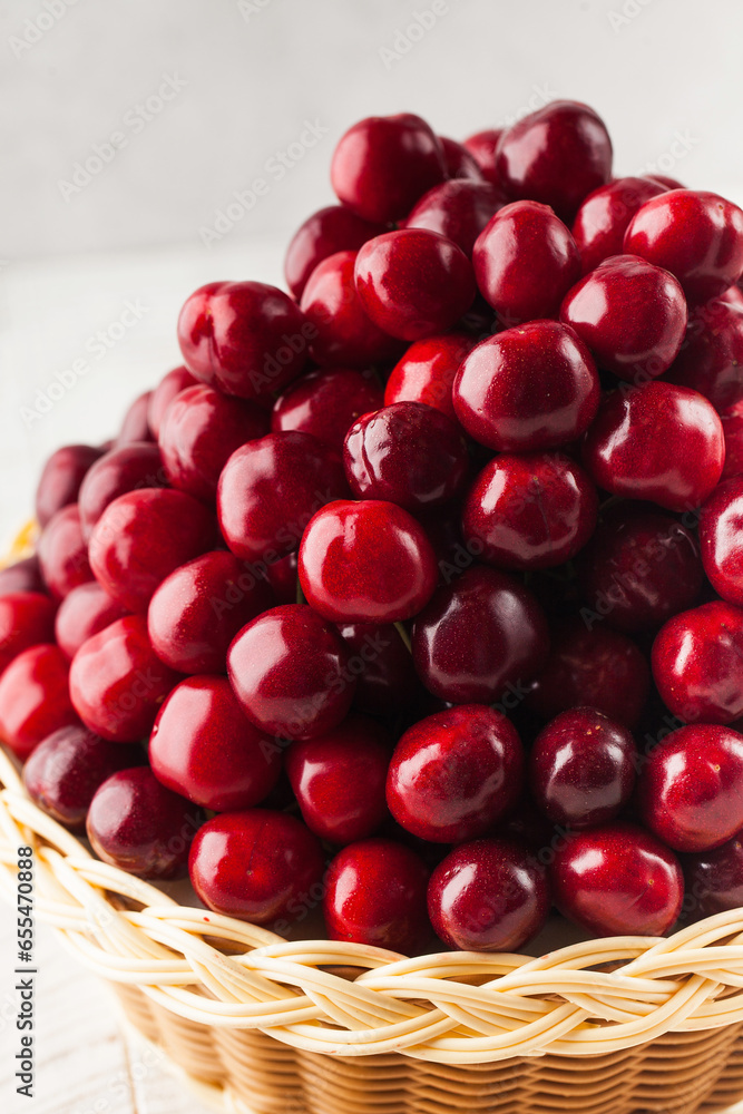 Ripe juicy cherries in a basket. The concept of berries. Ripe juicy cherries in a basket. The concept of berries.