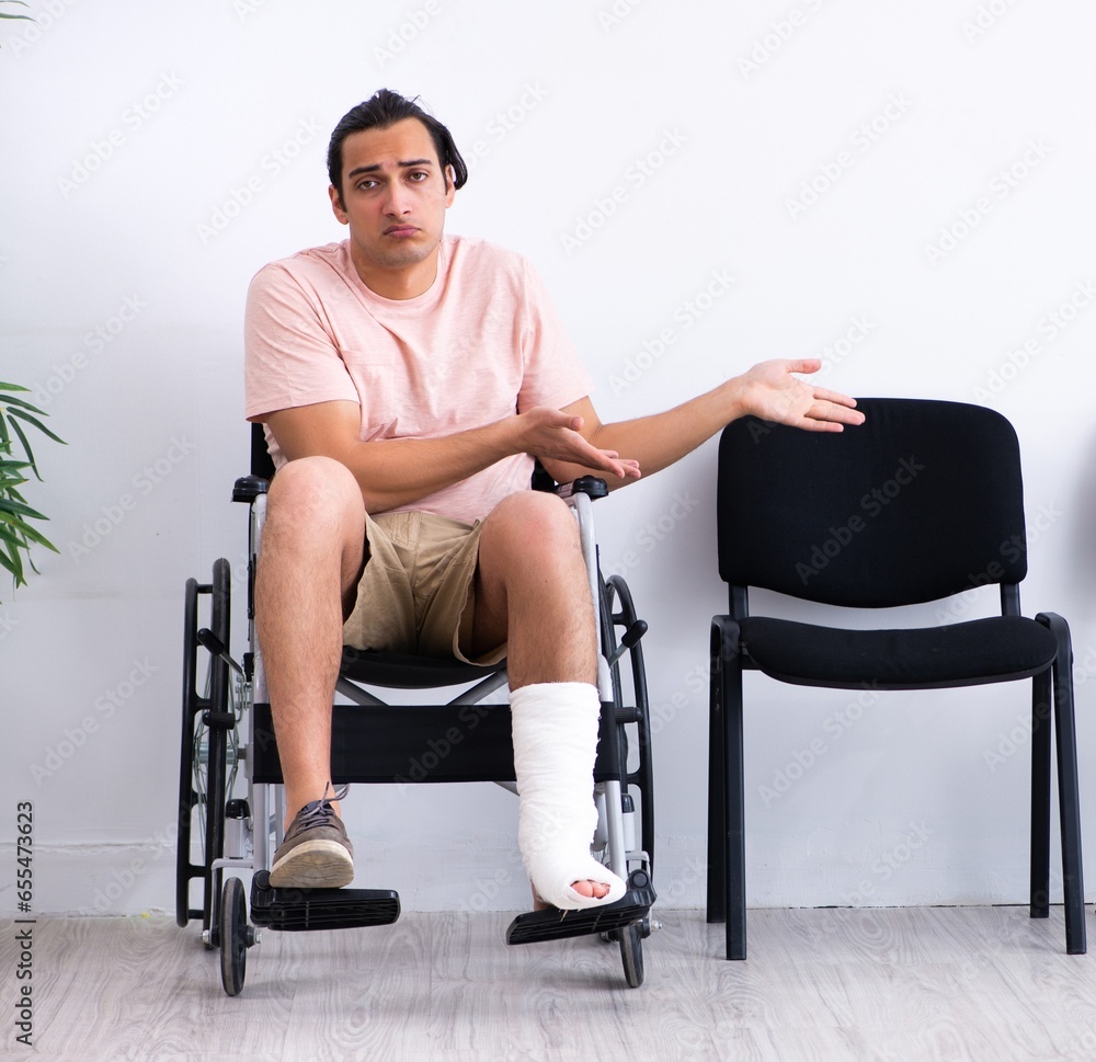 Young injured man waiting for his turn in hospital hall Young injured man waiting for his turn in hospital hall