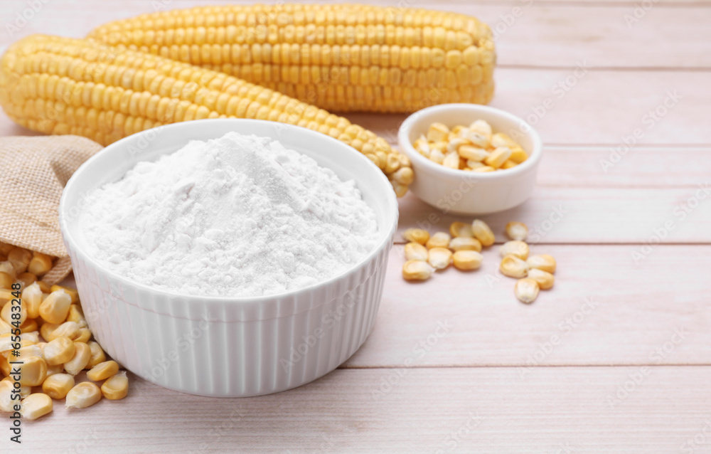 Bowl with corn starch, ripe cobs and kernels on wooden table. Space for text Bowl with corn starch, ripe cobs and kernels on wooden table. Space for text