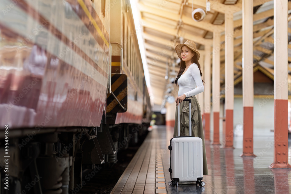 Woman traveler tourist walking with luggage at train station. Active and travel lifestyle concept Woman traveler tourist walking with luggage at train station. Active and travel lifestyle concept
