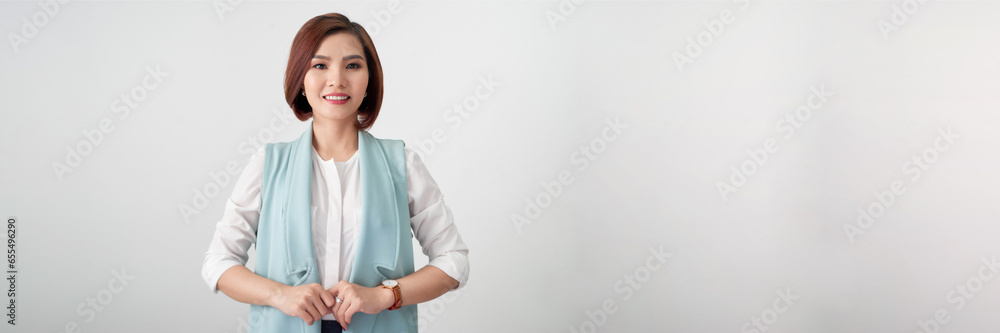 Beautiful young asian woman on a gray background in a white blouse. Panorama Beautiful young asian woman on a gray background in a white blouse. Panorama