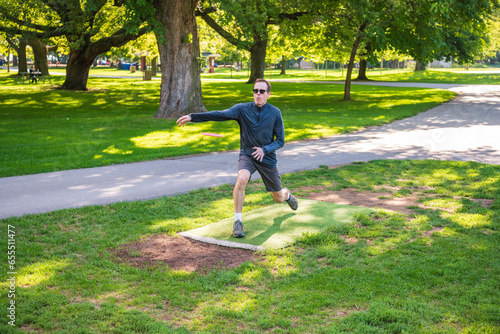 Disc golf is a flying disc sport in which players throw a disc at a target  played using rules like golf. © Michael Connor Photo