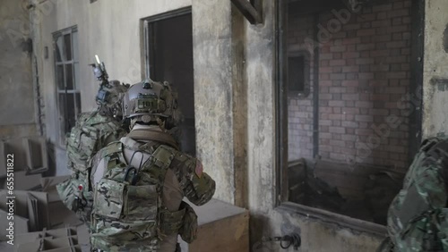 Soldier in civil war, ruined building. Close quarter battle and civil war concept.