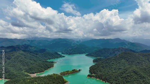 Cinematic panoramic shot above Fei-Ts'ui Reservoir with bright blue water and green jungle mountains, Taiwan photo