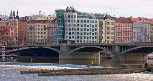 Dancing House and Jirásek bridge over Vltava river in Prague city. photo