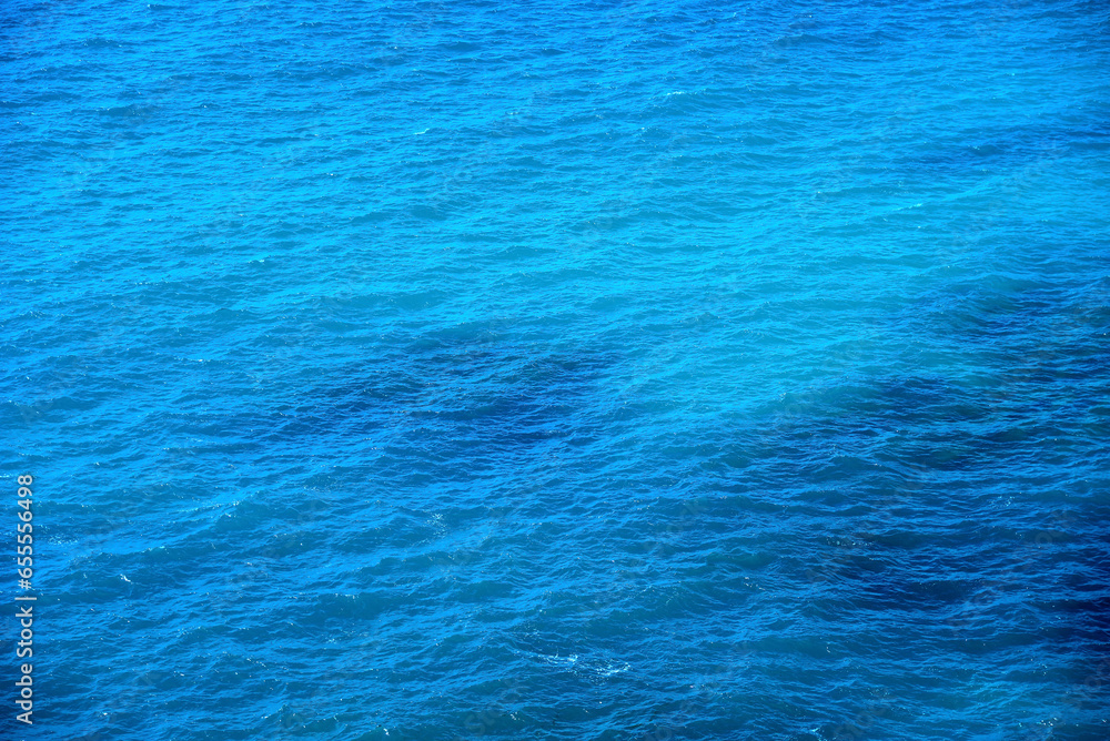 Sea surface with small waves. Blue water background. Marine texture. Sea surface with small waves. Blue water background. Marine texture.