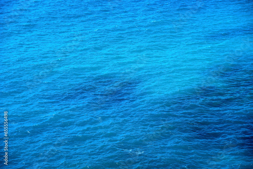 Sea surface with small waves. Blue water background. Marine texture.