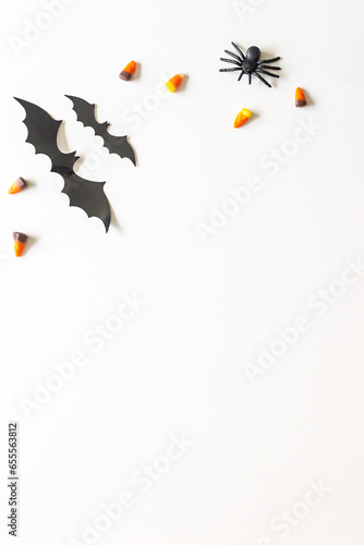 Vertical image of a halloween flatlay  bats  candy corn