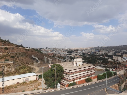 Beautiful daytime sky view of Al Bahah city in Saudi Arabia. City buildings, hills and clouds are visible in the background. photo