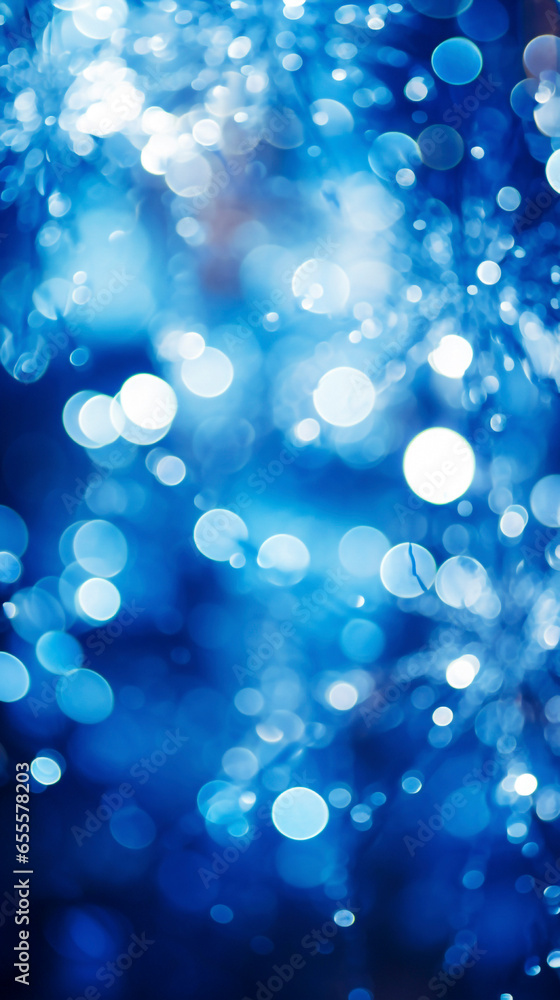 Blurred abstract blue christmas background with bokeh defocused lights.