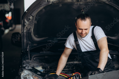 Mechanic connects air conditioning system