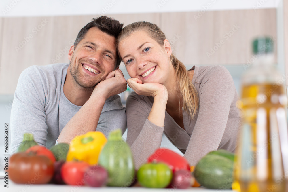 smiling couple at home with plentiful fruits smiling couple at home with plentiful fruits