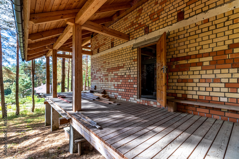 Fototapeta premium A house under construction in a pine forest on a sunny autumn day
