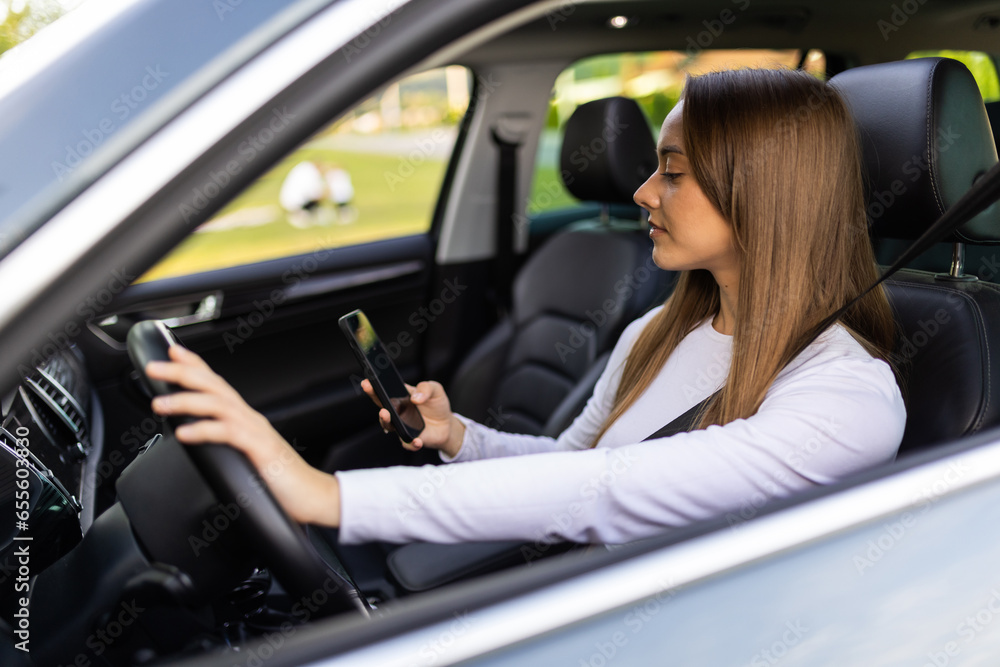 young woman driving car and talking on mobile phone. young woman driving car and talking on mobile phone.