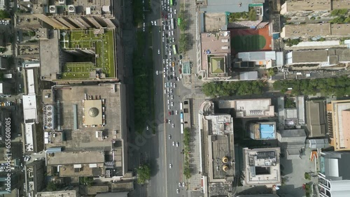 Bird-eye aerial drone view over street traffic at, Xian, large city and capital of Shaanxi Province in central China. Once known as Chang’an (Eternal Peace). Urbanization and development concept. UHD. photo