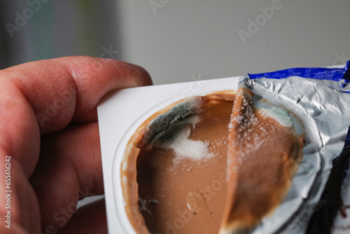 Close up of moldy mold on  cup of yogurt photo