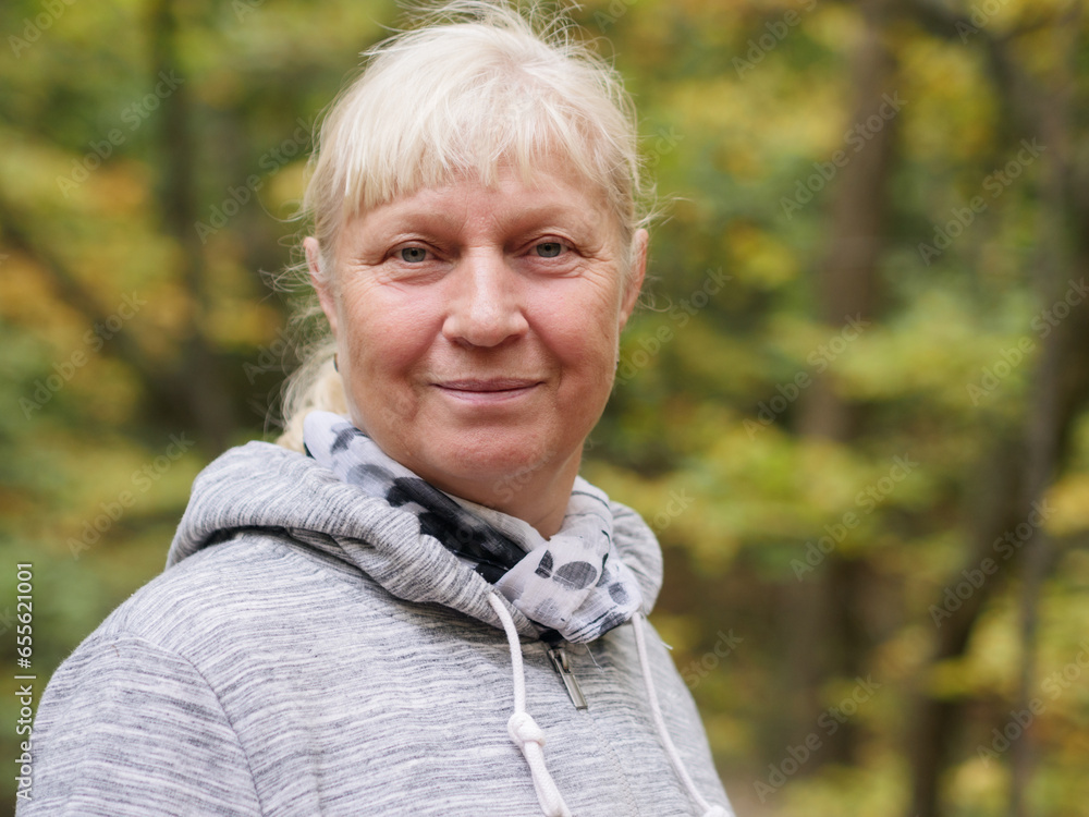 Portrait of a beautiful middle-aged woman in the park.