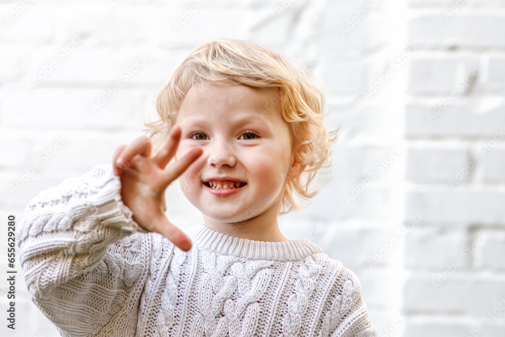 child gleefully displays four fingers, a playful and charming gesture child gleefully displays four fingers, a playful and charming gesture