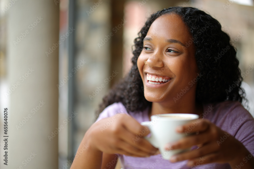 Happy black woman drinking coffee in a terrace Happy black woman drinking coffee in a terrace