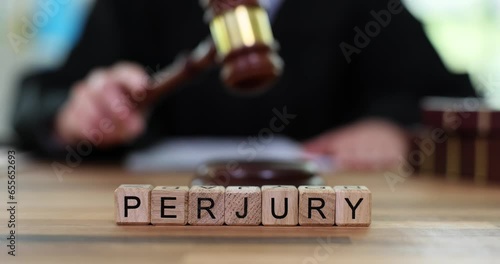 Word of perjury and judge and banging gavel on court table. Criminal liability for knowingly false testimony photo