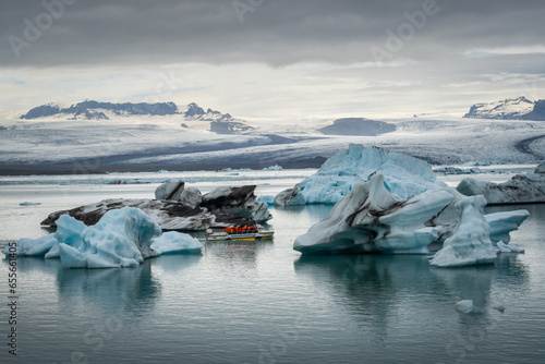 Boats at Diamond Beach and Jökulsárlón glacier lagoon in Iceland