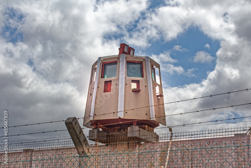 Hexagonal security tower with armored windows and gun-ports mounted on wall in South Africa photo