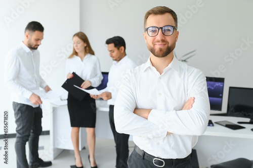 Team leader stands with coworkers in background