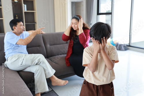 Young little asian boy depressed and upset while parent fighting and arguing