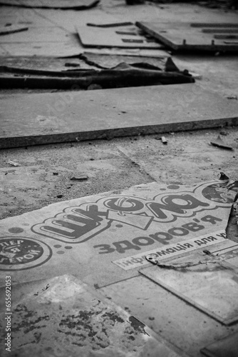 on the floor of the broken school there is a stand that reads "School of health. Information for. I am a hero"