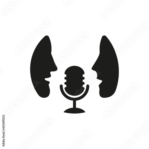 Two people talking into a microphone.