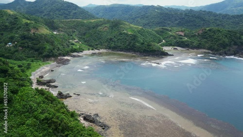 Picturesque Beach Surrounded With Lush Green Hills In Puraran, Baras, Catanduanes, Philippines - aerial shot photo