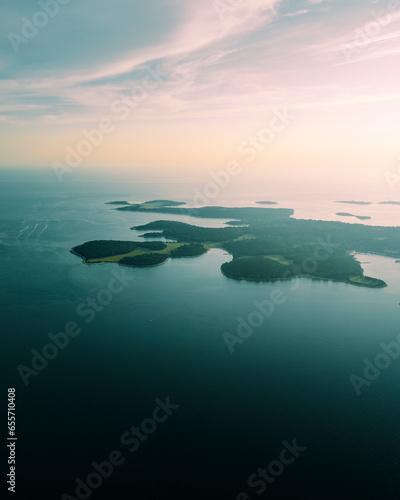 Aerial view of Brijuni National Park, a group of islands along the Adriatic Sea coastline with a misty fog at sunset near Pula, Istria, Croatia. photo