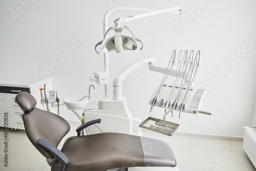 Dentist's office interior with modern chair and special dentisd equipment. Dentist office. Dentist chair in high class dental clinic. Dentist office. Medical concept. photo