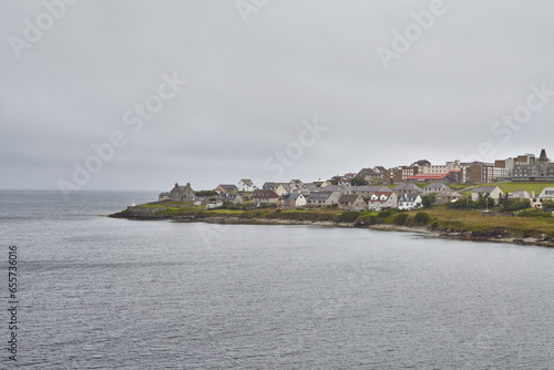 Lerwick island town center coastline surrounded by North Sea and grey sky.