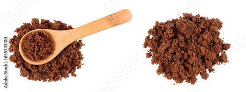 Dark muscovado sugar or Barbados sugar in wooden spoon isolated on white background. Top view. Flat lay photo