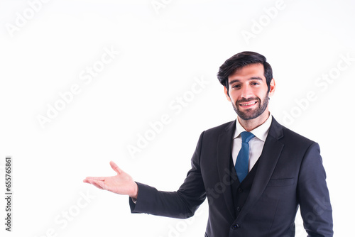 Businessman making a welcoming gesture with his arm out in front of a white background with copy space.