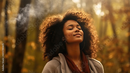 Black woman breaths fresh air on the forest