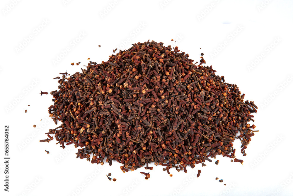 Dry spice cloves. Cloves spread on the ground on wooden background. Clove rustic style background spice concept. Dry spice cloves. Cloves spread on the ground on wooden background. Clove rustic style background spice concept.
