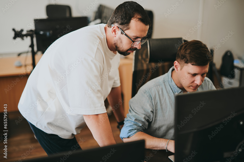 Portrait of two professional male programmers working on computer in diverse offices. Modern IT technologies, development of artificial intelligence, programs, applications and video games concept Portrait of two professional male programmers working on computer in diverse offices. Modern IT technologies, development of artificial intelligence, programs, applications and video games concept