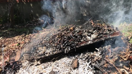 Dry leaves, branches and wood, burning.
No fire, just dots of white smoke. Take from right to left.