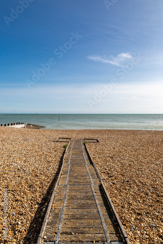 A wooden ramp on the pebble beach at Eastbourne  on a sunny September day