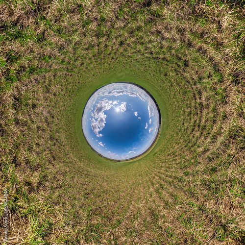 blue hole sphere little planet inside green grass round frame background.