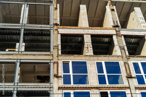 glazing with double-glazed windows construction of a high-rise building, view from bottom to top photo