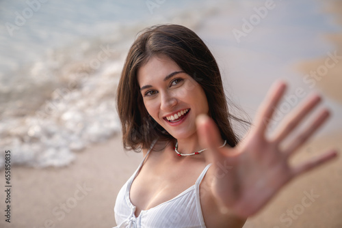 Close Up face of Beautiful Woman in Bikini Enjoying life on Tropical beach. Female on Sandy Beach Relaxing. Summer Vacation time.