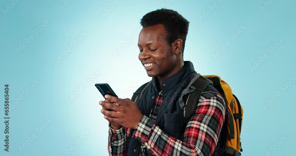 Phone, search and travel with black man with backpack in studio for travel, hiking or text on blue background. Smartphone, app and happy African person with location or social media communication Phone, search and travel with black man with backpack in studio for travel, hiking or text on blue background. Smartphone, app and happy African person with location or social media communication