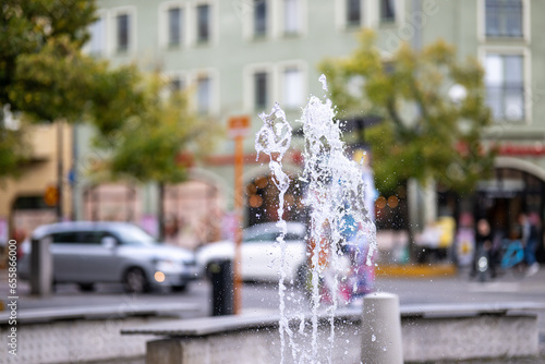 Fototapeta Naklejka Na Ścianę i Meble -  Skvallertorget or Gossip square during early fall with a small fountain in Norrköping, Sweden.  Norrkoping is a historic industrial town.