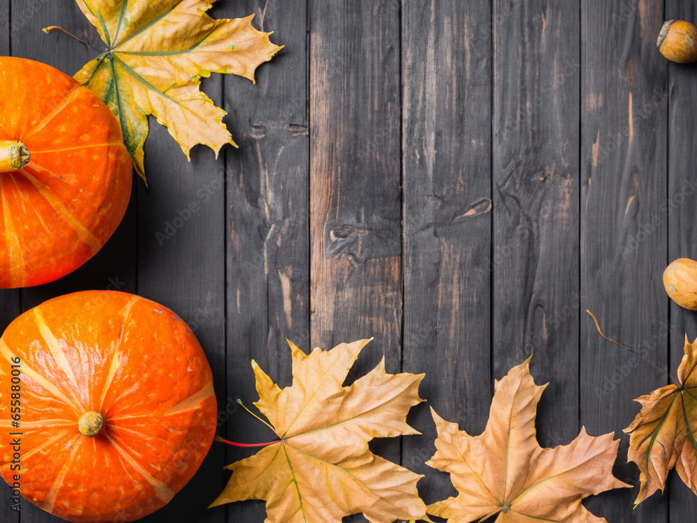 pumpkin and leaves on wooden background pumpkin and leaves on wooden background