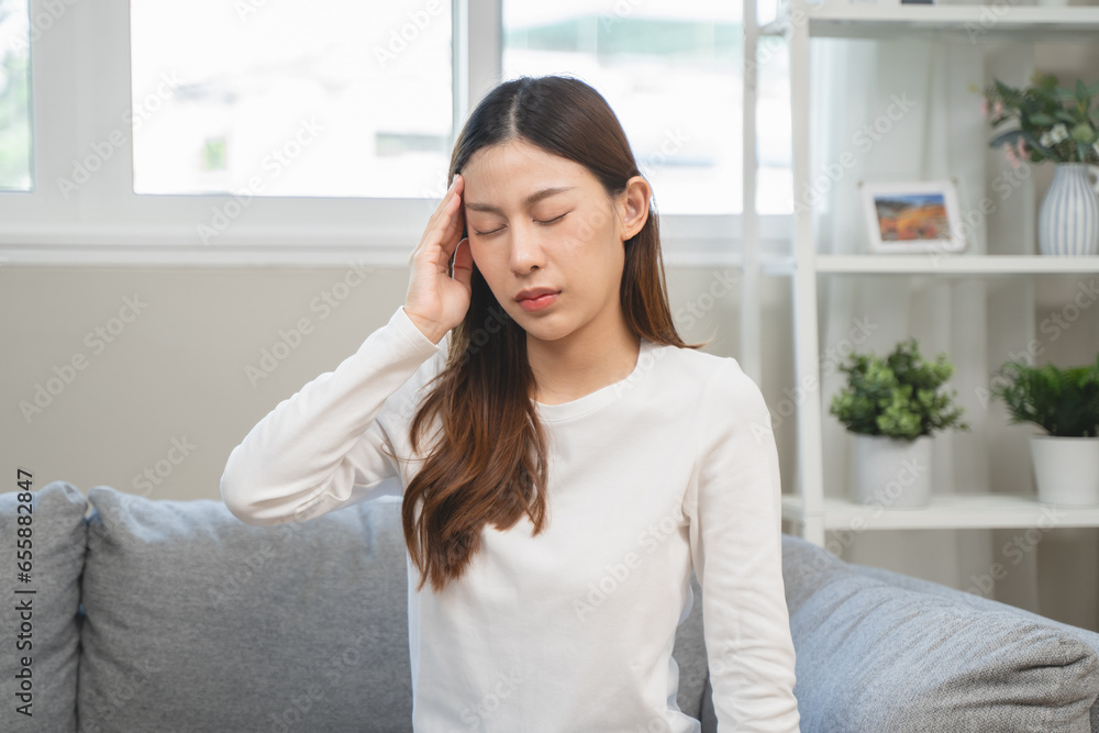 Brain stroke or low blood pressure symptom on people medical concept. Young beautiful woman has a dizziness and motion blurry during standing off sofa at home Brain stroke or low blood pressure symptom on people medical concept. Young beautiful woman has a dizziness and motion blurry during standing off sofa at home